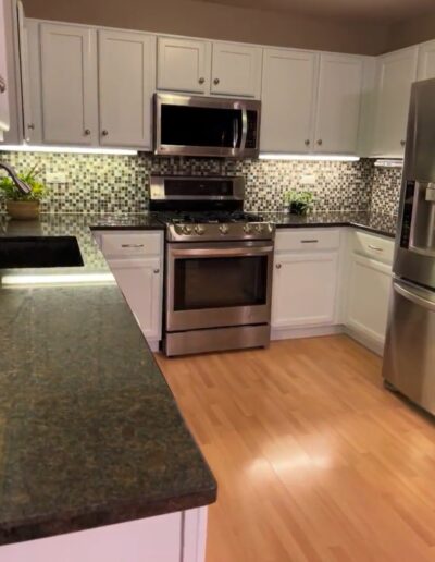 A kitchen with stainless steel appliances and granite counter tops.