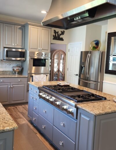 A kitchen with blue cabinets and granite counter tops.