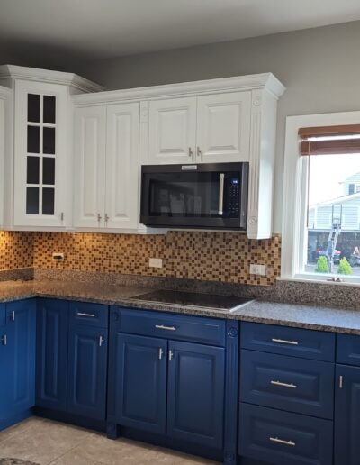 A kitchen with blue and white cabinets.