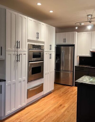 A kitchen with white cabinets and stainless steel appliances.