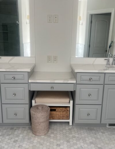 A bathroom with two sinks and a mirror.