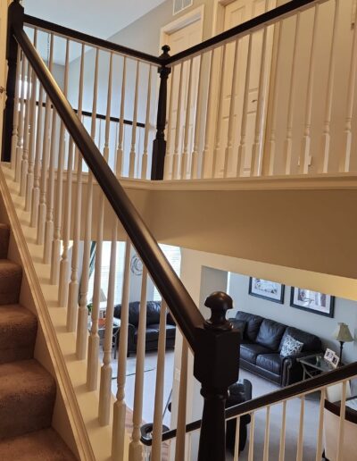 A staircase in a home with black railings.