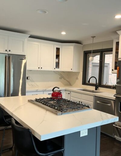 A kitchen with white cabinets and stainless steel appliances.