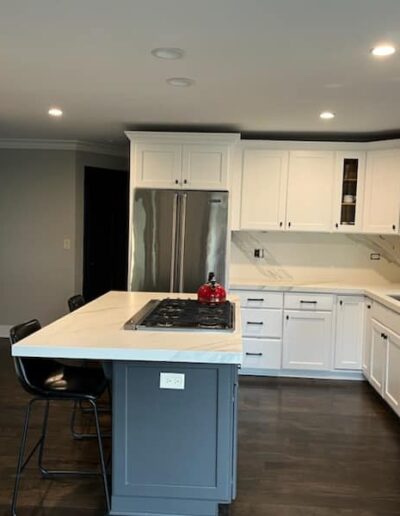 A kitchen with white cabinets and stainless steel appliances.