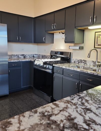 A kitchen with stainless steel appliances and granite counter tops.