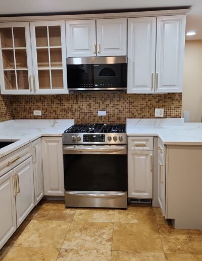 A kitchen with white cabinets and stainless steel appliances.